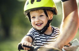 Portrait of smiling toddler wearing cycling helmet